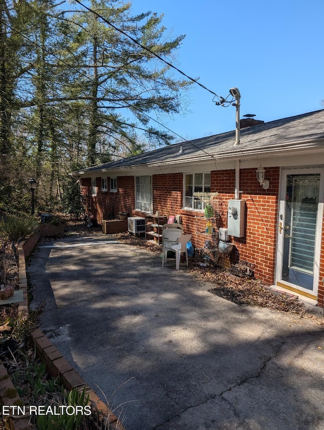 view of side of property featuring brick siding