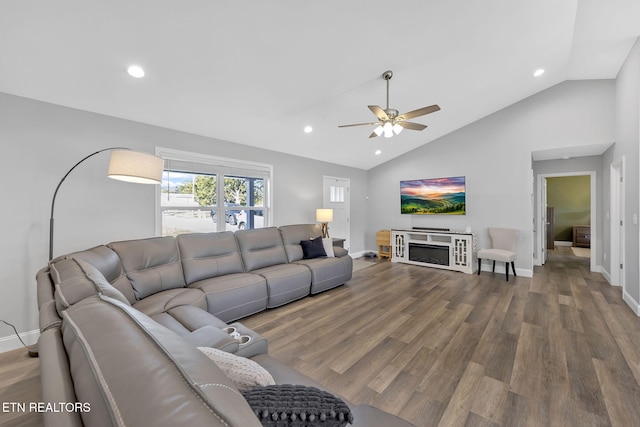 living room featuring recessed lighting, a fireplace, wood finished floors, baseboards, and vaulted ceiling