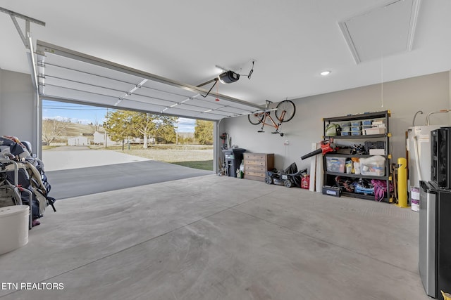 garage featuring water heater and a garage door opener