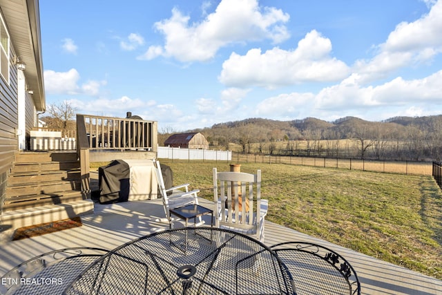 view of patio / terrace featuring outdoor dining space, a mountain view, fence, and stairs