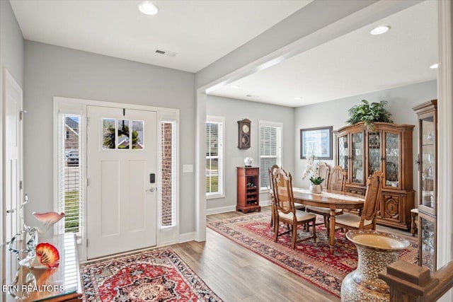 entrance foyer with recessed lighting, visible vents, baseboards, and wood finished floors