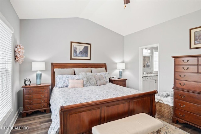 bedroom featuring lofted ceiling, dark wood-style floors, ceiling fan, and connected bathroom