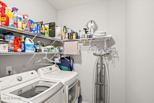 clothes washing area with laundry area and washer and clothes dryer