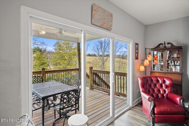 doorway featuring baseboards and wood finished floors