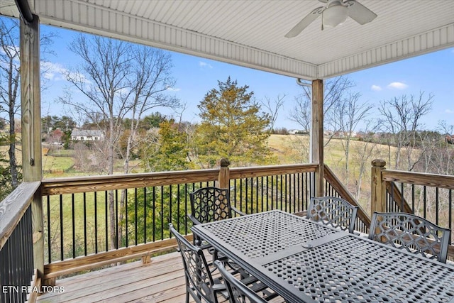 wooden deck featuring a ceiling fan and outdoor dining area