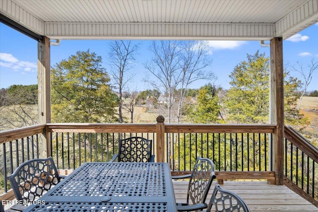 wooden deck featuring outdoor dining space