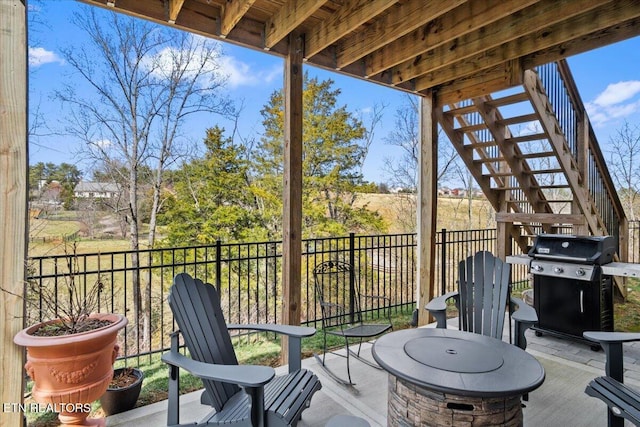 view of patio / terrace with stairs and area for grilling