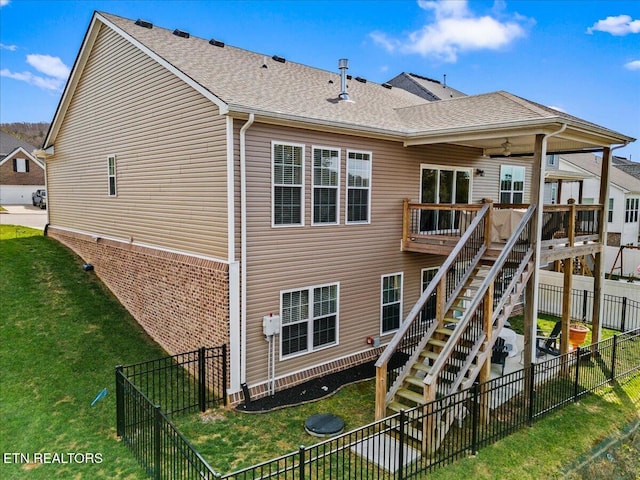 rear view of house featuring a lawn, ceiling fan, a fenced backyard, stairway, and a deck