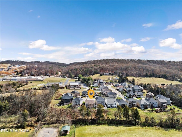 drone / aerial view with a residential view and a wooded view