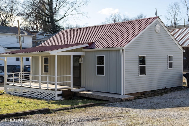 rear view of property with a standing seam roof and metal roof