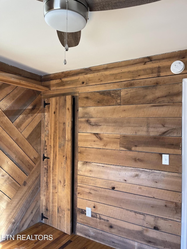 details with wooden walls and wood finished floors