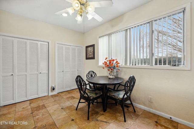 dining room with ceiling fan and baseboards