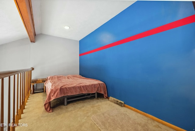 bedroom with lofted ceiling, carpet flooring, visible vents, and baseboards