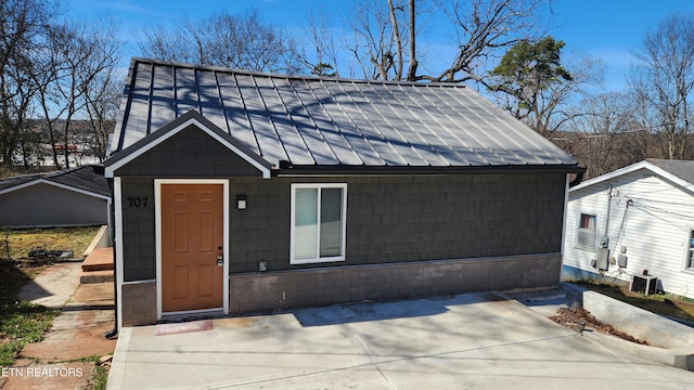 view of front of house with a standing seam roof and metal roof