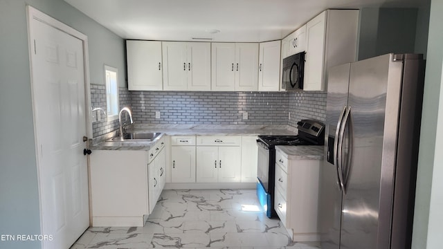 kitchen featuring black microwave, range with electric cooktop, a sink, marble finish floor, and stainless steel refrigerator with ice dispenser