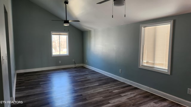 empty room with vaulted ceiling, dark wood-style flooring, a ceiling fan, and baseboards