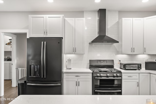 kitchen with washing machine and clothes dryer, tasteful backsplash, fridge with ice dispenser, double oven range, and wall chimney exhaust hood