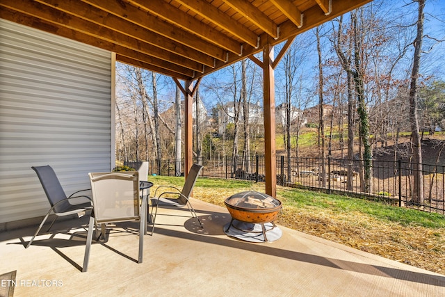 view of patio / terrace featuring outdoor dining space, an outdoor fire pit, and fence