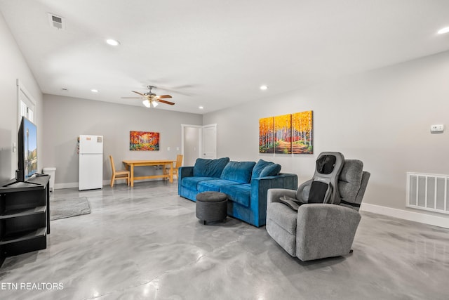 living room featuring baseboards, finished concrete floors, visible vents, and recessed lighting