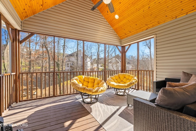 sunroom / solarium with vaulted ceiling, wood ceiling, and a ceiling fan