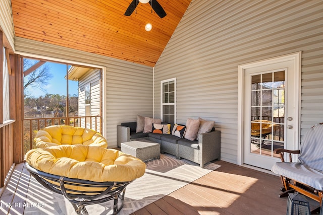 sunroom featuring lofted ceiling and a ceiling fan