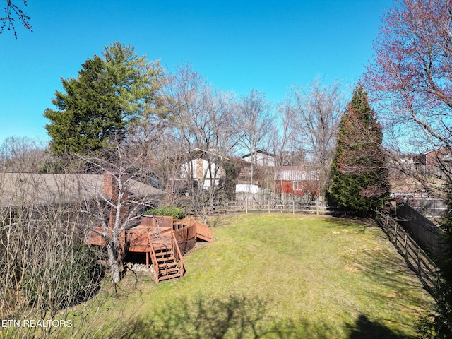 view of yard featuring stairway, fence, and a wooden deck