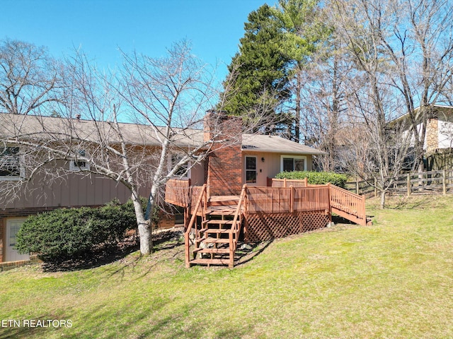 back of house featuring stairs, a deck, and a yard