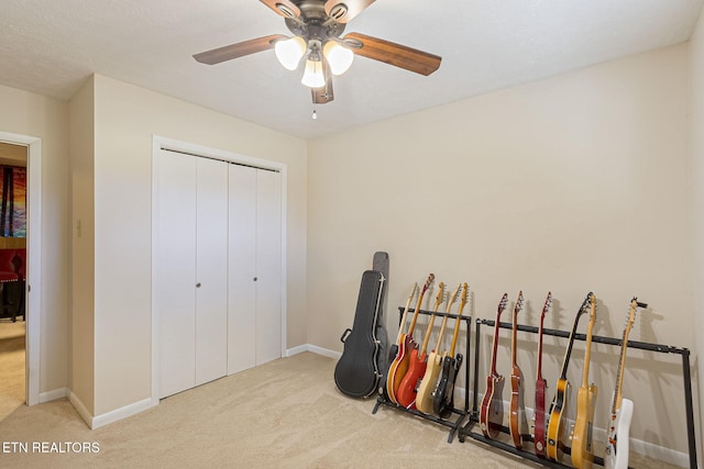 interior space with ceiling fan, carpet floors, and baseboards