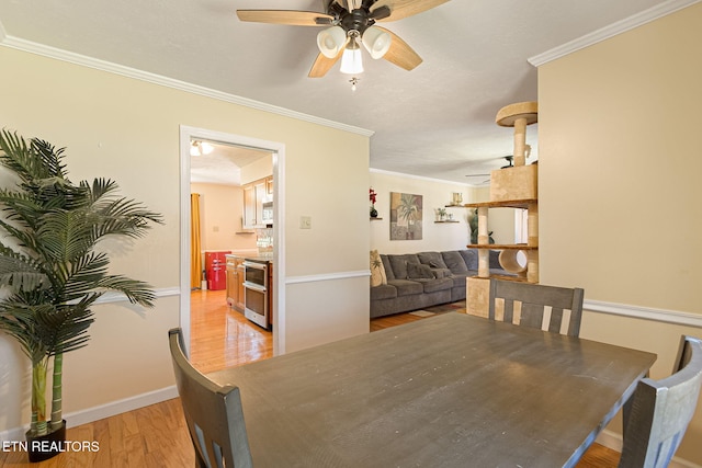 dining room with ceiling fan, baseboards, light wood-style flooring, and crown molding