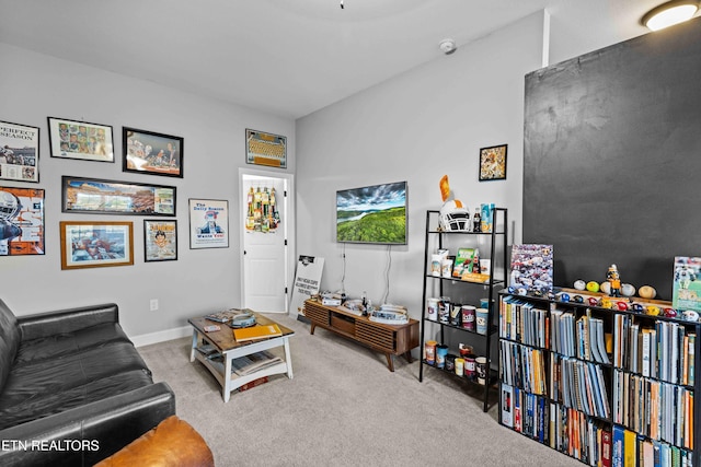 living area with baseboards and carpet flooring