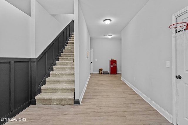 stairs with baseboards and wood finished floors