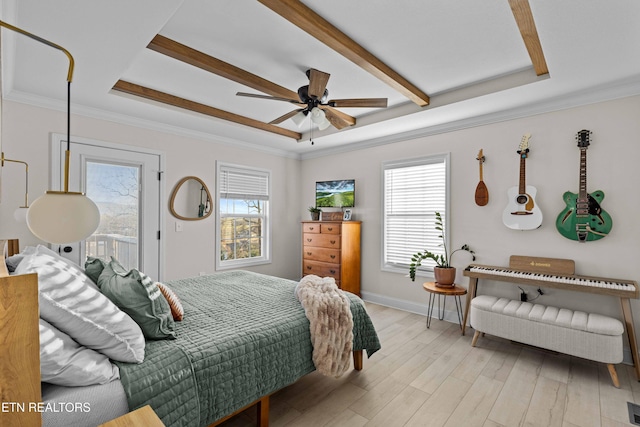 bedroom featuring baseboards, light wood-style flooring, access to outside, a tray ceiling, and crown molding