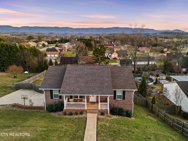 aerial view at dusk with a residential view and a mountain view