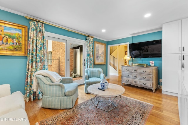 living room featuring recessed lighting, stairs, light wood-style floors, and ornamental molding