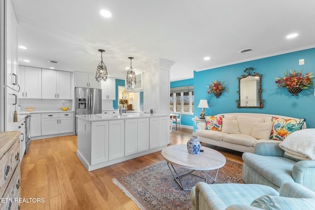 living room featuring recessed lighting, visible vents, and light wood finished floors