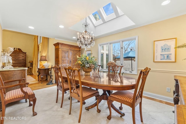 dining room with baseboards, a skylight, recessed lighting, ornamental molding, and a notable chandelier