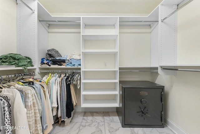 spacious closet with marble finish floor