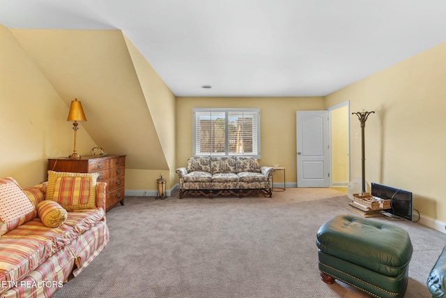 living area featuring carpet and baseboards