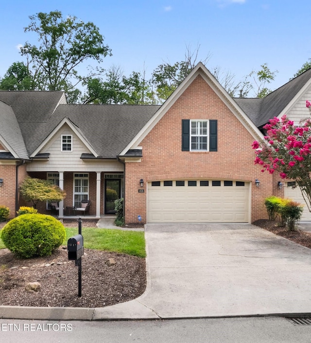 view of front of home with a garage, concrete driveway, brick siding, and roof with shingles