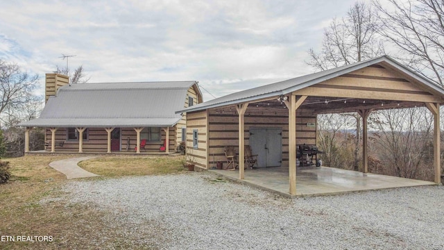 exterior space with a carport and driveway