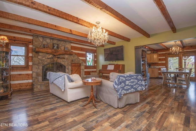 living area with a chandelier, a fireplace, plenty of natural light, and dark wood finished floors