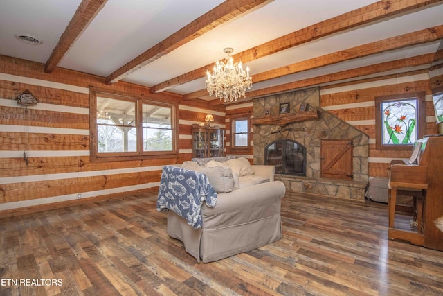 living room with wood walls, wood finished floors, and a healthy amount of sunlight