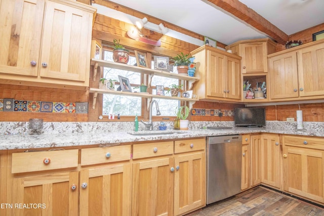 kitchen with light brown cabinets, stainless steel dishwasher, beamed ceiling, and a sink