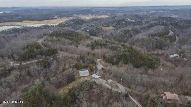 drone / aerial view with a wooded view