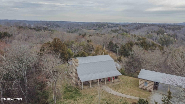 drone / aerial view featuring a wooded view