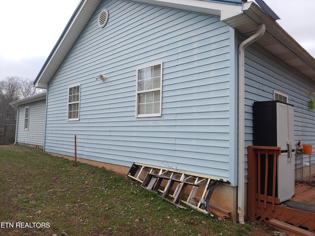 view of side of home featuring a yard