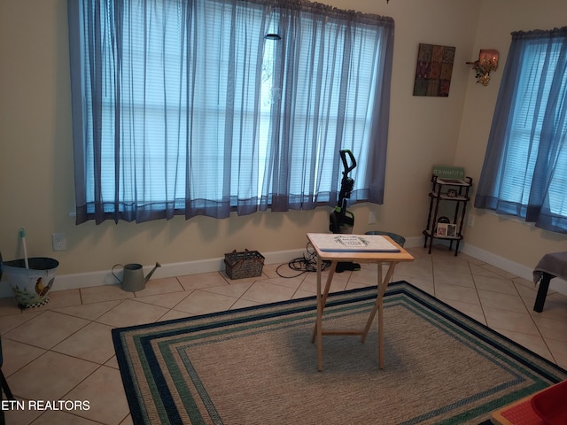 office space with baseboards and tile patterned floors