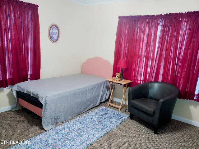 bedroom with carpet, crown molding, and baseboards