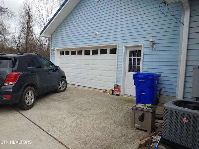 garage with driveway and central AC