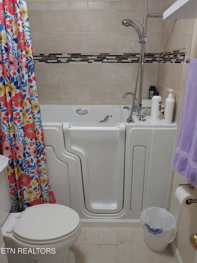 full bathroom featuring toilet, tile patterned flooring, a bathtub, and a shower with curtain